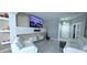 Bright living room with modern white furniture, tiled floors, stylish wall accents, and natural light at 4730 Capital Blvd, St Cloud, FL 34769