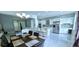 Spacious living area with kitchen island and dining table, perfect for entertaining at 4730 Capital Blvd, St Cloud, FL 34769