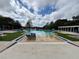 A view of the community pool with lounge chairs and well maintained landscaping at 4730 Capital Blvd, St Cloud, FL 34769