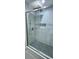 Modern bathroom shower with wave tile and mosaic floor at 4730 Capital Blvd, St Cloud, FL 34769