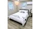 Cozy bedroom with a queen bed, stylish décor, and natural light from two windows at 5237 Davisson Ave, Orlando, FL 32810