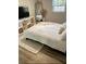 Bright bedroom featuring a bed, side table and white cover, with a modern wicker storage cube stand at 5237 Davisson Ave, Orlando, FL 32810