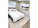 Bright bedroom with a queen bed and neutral colored rug and decor at 5237 Davisson Ave, Orlando, FL 32810