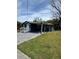 Charming home with a well-manicured lawn, a covered porch, and a paved driveway at 5237 Davisson Ave, Orlando, FL 32810