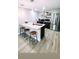 Bright kitchen with stainless steel appliances, counter seating, and wood look vinyl plank flooring at 5237 Davisson Ave, Orlando, FL 32810