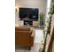 Inviting living room with a decorative ladder, TV and modern media console, with wood floors and large plant at 5237 Davisson Ave, Orlando, FL 32810