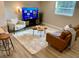 A cozy living area features stylish furniture, a neutral rug, and light-colored wood floors at 5237 Davisson Ave, Orlando, FL 32810