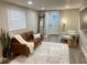Well-lit living room featuring a sofa, accent chair, and stylish decorations at 5237 Davisson Ave, Orlando, FL 32810