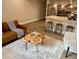 Spacious living room featuring unique wood coffee tables, a comfy couch, and kitchen bar seating at 5237 Davisson Ave, Orlando, FL 32810