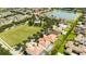 Aerial view of a home in a well-planned community with a lake, green space, and community pool at 6008 Golden Dewdrop Trl, Windermere, FL 34786