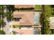 Aerial view of home showing screened-in pool, brown roof, and an attached two-car garage at 6008 Golden Dewdrop Trl, Windermere, FL 34786