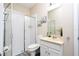 Bright bathroom features a glass door shower and a single sink vanity with decorative art at 6008 Golden Dewdrop Trl, Windermere, FL 34786