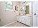 Neutral bathroom with white vanity, framed art, and tiled floor offers a clean, bright space at 6008 Golden Dewdrop Trl, Windermere, FL 34786