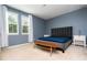Bedroom features a modern gray bed, two windows, and light blue walls at 6008 Golden Dewdrop Trl, Windermere, FL 34786