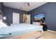 Bedroom featuring a large TV and comfortable furnishings at 6008 Golden Dewdrop Trl, Windermere, FL 34786