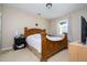 Cozy bedroom featuring a large wooden bed, a window and soft carpeting at 6008 Golden Dewdrop Trl, Windermere, FL 34786