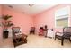 Bedroom with pink walls, desk, and decor at 6008 Golden Dewdrop Trl, Windermere, FL 34786