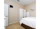 Simple bedroom with a wardrobe, white linens and clean, neutral walls at 6008 Golden Dewdrop Trl, Windermere, FL 34786