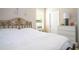 Bright bedroom featuring a gold metal bed frame, white linens, and neutral walls at 6008 Golden Dewdrop Trl, Windermere, FL 34786