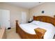 Comfortable bedroom with neutral walls and carpeting, and a large wooden bed at 6008 Golden Dewdrop Trl, Windermere, FL 34786