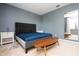 Bedroom features a modern gray bed, two side tables and a wooden bench at 6008 Golden Dewdrop Trl, Windermere, FL 34786