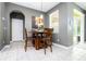 Cozy dining area with a wooden table, chairs, and a view of the outside patio at 6008 Golden Dewdrop Trl, Windermere, FL 34786