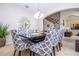 Spacious dining room with modern table, decorative mirror, and view towards the staircase at 6008 Golden Dewdrop Trl, Windermere, FL 34786