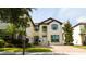 Charming two-story home with a brick driveway, manicured lawn, and lush landscaping at 6008 Golden Dewdrop Trl, Windermere, FL 34786