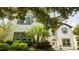 Stately two-story home with brown trim, a manicured lawn, and mature tropical landscaping at 6008 Golden Dewdrop Trl, Windermere, FL 34786