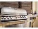 A large, stainless steel grill under a sheltered area with hooks and cooking tools at 6008 Golden Dewdrop Trl, Windermere, FL 34786