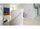 Bright hallway with carpet, white trim, and an adjacent sitting area provides an airy transition space at 6008 Golden Dewdrop Trl, Windermere, FL 34786