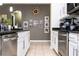 Kitchen with white cabinetry, stainless steel appliances, and granite countertops at 6008 Golden Dewdrop Trl, Windermere, FL 34786