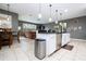 Open-concept kitchen featuring stainless steel appliances, tile flooring and an island with pendant lighting at 6008 Golden Dewdrop Trl, Windermere, FL 34786