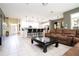 Open concept living room flows into the kitchen with tile flooring and a comfortable, oversized sofa at 6008 Golden Dewdrop Trl, Windermere, FL 34786