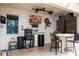 The outdoor kitchen has a grill, a bar with chairs and two ceiling fans at 6008 Golden Dewdrop Trl, Windermere, FL 34786