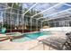 An aerial view of a beautiful screened-in pool with a jacuzzi and lounge chairs at 6008 Golden Dewdrop Trl, Windermere, FL 34786