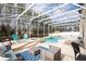 Enclosed private pool and spa with bamboo backdrop, covered seating, and ample lounging space at 6008 Golden Dewdrop Trl, Windermere, FL 34786