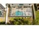 Aerial view of a screened-in pool with patio furniture and a landscaped backyard at 6008 Golden Dewdrop Trl, Windermere, FL 34786
