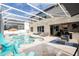 Beautiful screened-in pool with jacuzzi and outdoor kitchen under a bright, airy enclosure at 6008 Golden Dewdrop Trl, Windermere, FL 34786