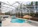 Wide aerial shot of a luxurious screened-in pool and backyard with a variety of seating and water features at 6008 Golden Dewdrop Trl, Windermere, FL 34786