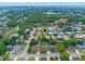 An aerial view showcases a quiet neighborhood featuring well-kept homes, mature trees, and local ponds at 6031 W Ridgewood Ave, Orlando, FL 32835