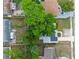 Overhead view of the property's roof and large backyard with a mature tree at 6031 W Ridgewood Ave, Orlando, FL 32835