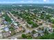 This aerial shot displays a vibrant community featuring neatly arranged houses, interspersed with lush greenery and quiet streets at 6031 W Ridgewood Ave, Orlando, FL 32835