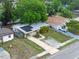 Aerial view of the home, showing the driveway, yard and solar panels on the roof at 6031 W Ridgewood Ave, Orlando, FL 32835