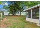 Lush backyard with mature trees, a white vinyl fence, and a screened porch offers privacy and outdoor enjoyment at 6031 W Ridgewood Ave, Orlando, FL 32835