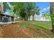 Spacious backyard featuring mature trees and a screened porch, creating a peaceful outdoor oasis at 6031 W Ridgewood Ave, Orlando, FL 32835