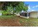 This large backyard with mature trees and a screened in porch is great for outdoor enjoyment at 6031 W Ridgewood Ave, Orlando, FL 32835