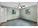 Bedroom features two windows for natural light, ceiling fan, and neutral walls at 6031 W Ridgewood Ave, Orlando, FL 32835