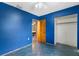 Bedroom featuring blue walls and ceiling fan; an open closet and doorway lead to other rooms at 6031 W Ridgewood Ave, Orlando, FL 32835