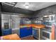 Well-lit kitchen featuring stainless steel appliances, blue cabinets, and stylish wood countertop at 6031 W Ridgewood Ave, Orlando, FL 32835